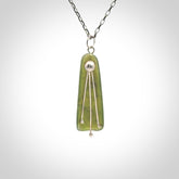 This kowhai flower drop pendant is beautifully hand made with gorgeous flair. It is fashionable and perfect for a women with style. Hand carved from a gorgeous piece of New Zealand jade with sterling silver - this is an elegant and beautiful piece of art to wear.
